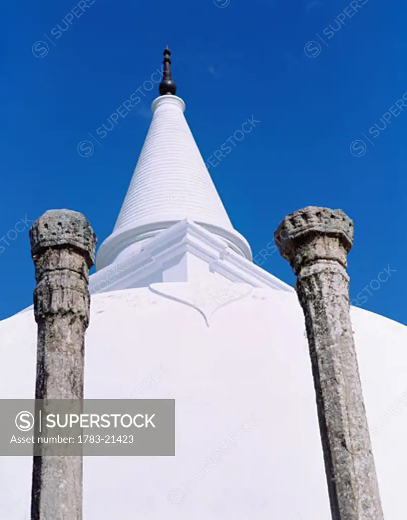 White stupa and granite columns at Lankarama Dagoba , Anuradhapura, North Central Province, Sri Lanka