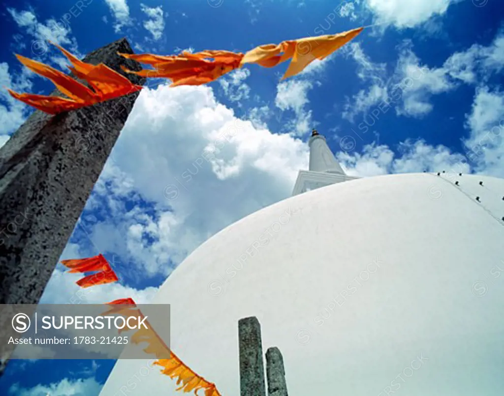 White stupa of Ruwanveliseya Dagoba with orange prayer flags,  Anuradhapura, North Central Province, Sri Lanka