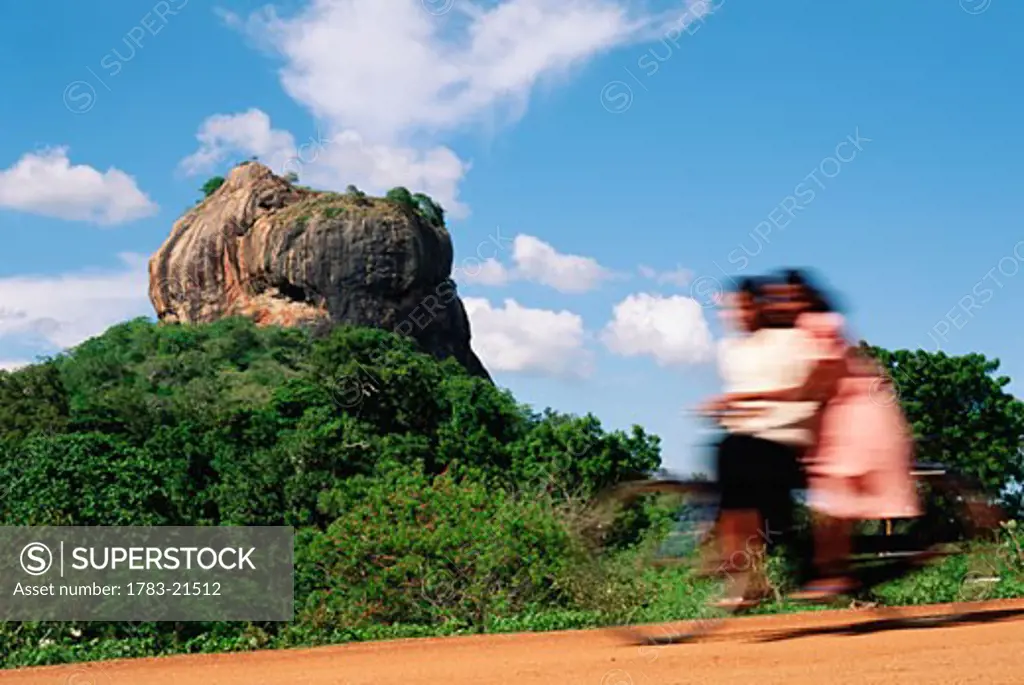 Girls on bicycle on dirt road, Sigiriya Lion Rock Fortress, Sigiriya, Sri Lanka