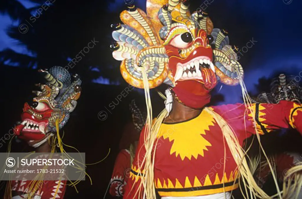 Dancers wearing masks during traditional festival, Sri Lanka.
