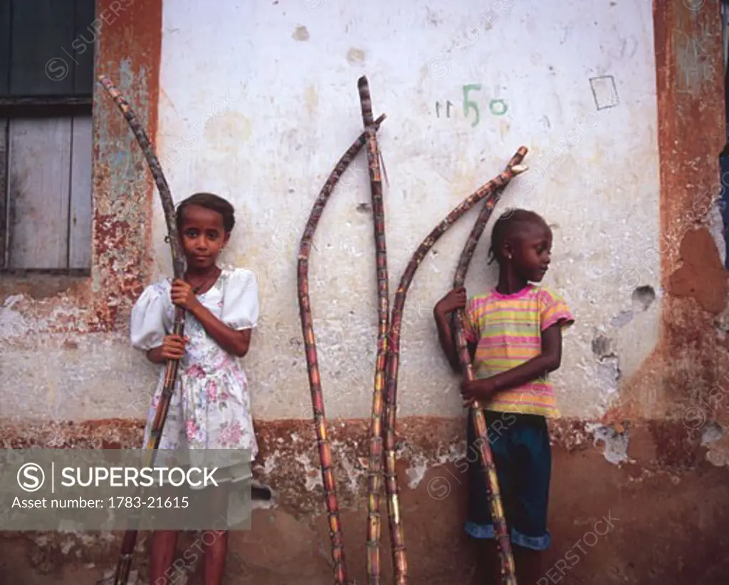 Girls holding sugar cane, Democratic Republic of Sao Tome and Principe, Principle Island.