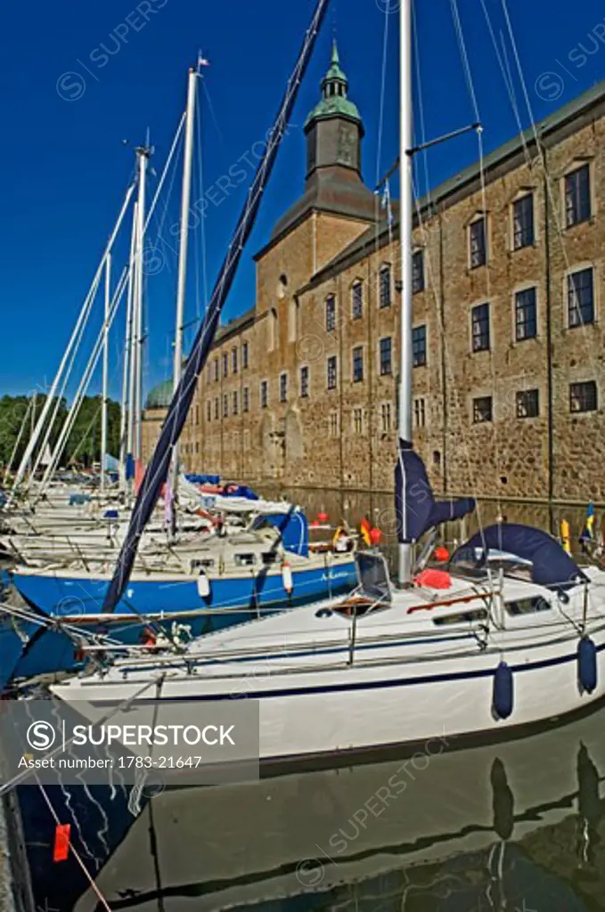 Yachts anchoring in moat at Vadstena Castle., Ostergotland, Sweden. 