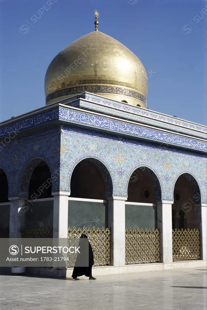 Muslim woman walking by Tomb of Fatima's daughter at Zainab Mosque, Damascus, Syria