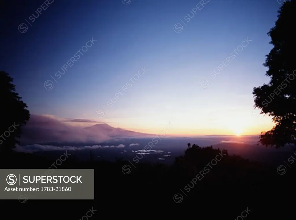 View from the forests of Mt Meru to dawn over Mount Kilimanjaro, Tanzania