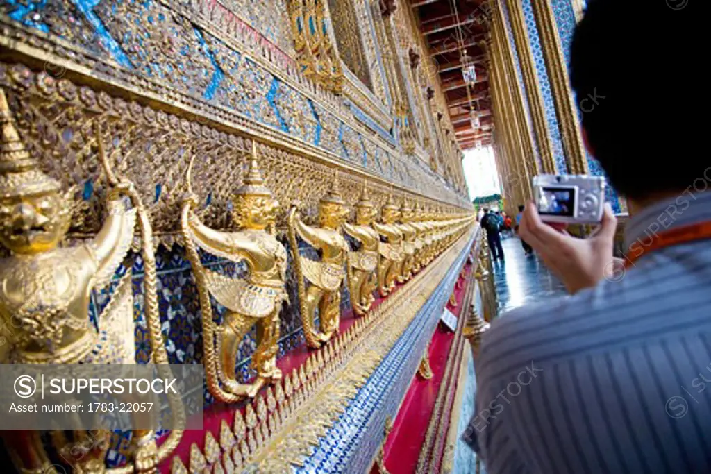 Man taking pictures on the bot of Wat Phra Kaeo, Bangkok, Thailand
