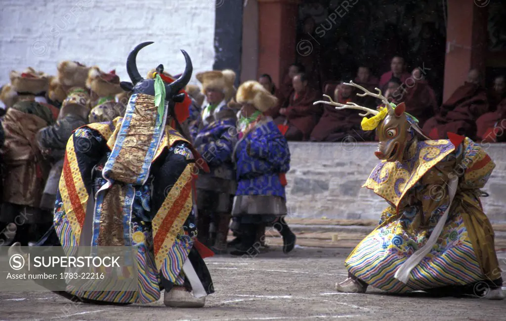 Monks dressed as Cham dancers performing fight between Good and Evil during Grand Summons of Labuleng Monastery, Labrang Monastery, Xiahe County, Gansu province, Tibet.