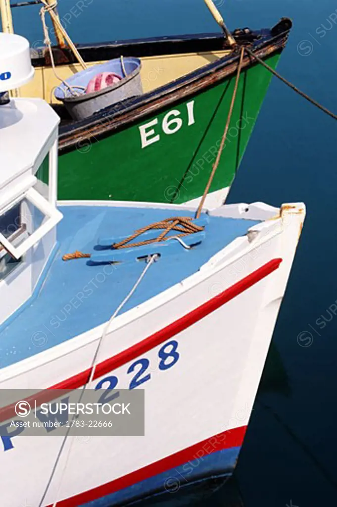 Two painted fishing boats in harbour, close up, Padstow, Cornwall, England
