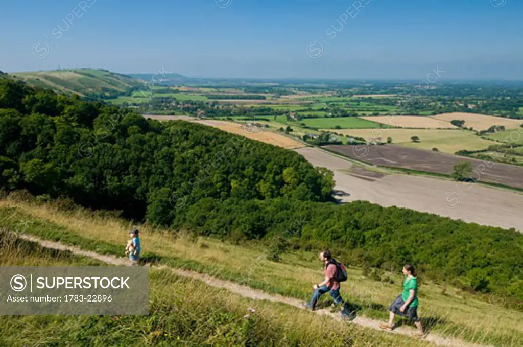 Couple with boy walking along path at Devil's Dyke near Brighton, East Sussex, England..