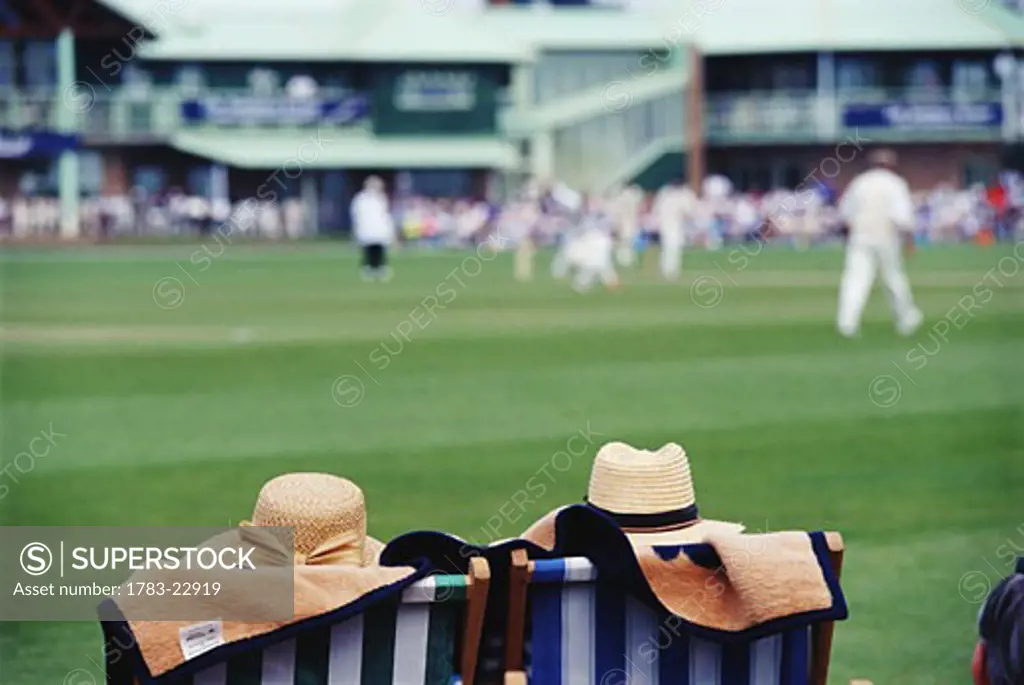 Men watching cricket game, Hastings, East Sussex, England