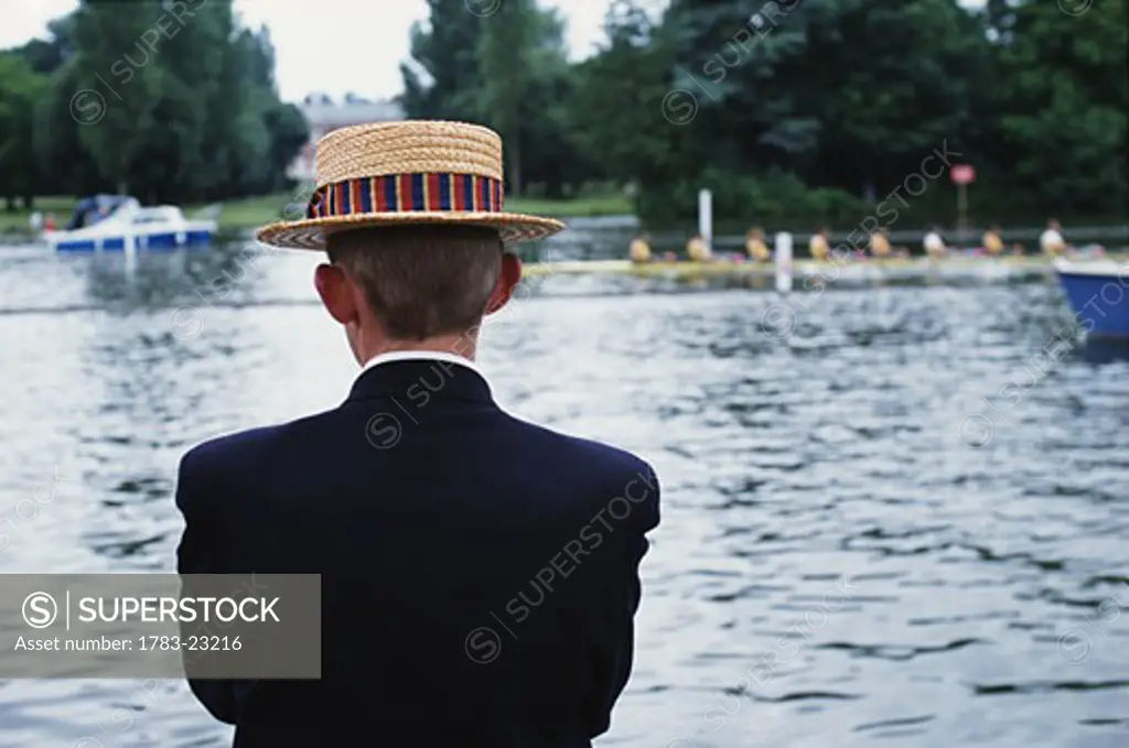 Man on the bank of the Thames during Henley Royal Regatta, Oxfordshire, England