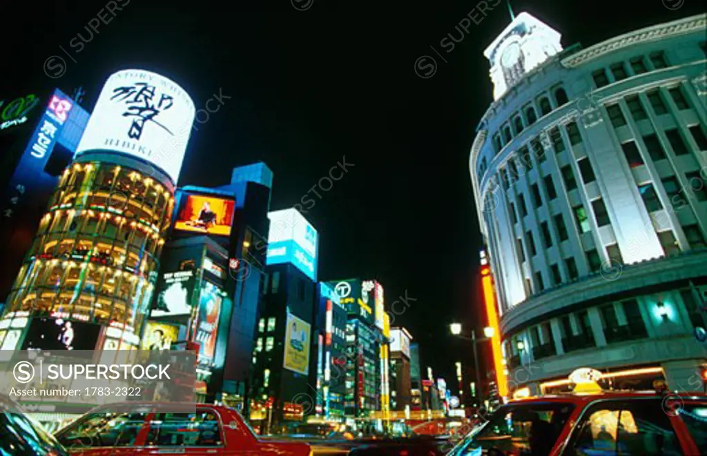 Brand new Suntory Whiskey advert on the famous San-ai Building at ChuoDori. Wako Department Store on right. Tokyo Japan