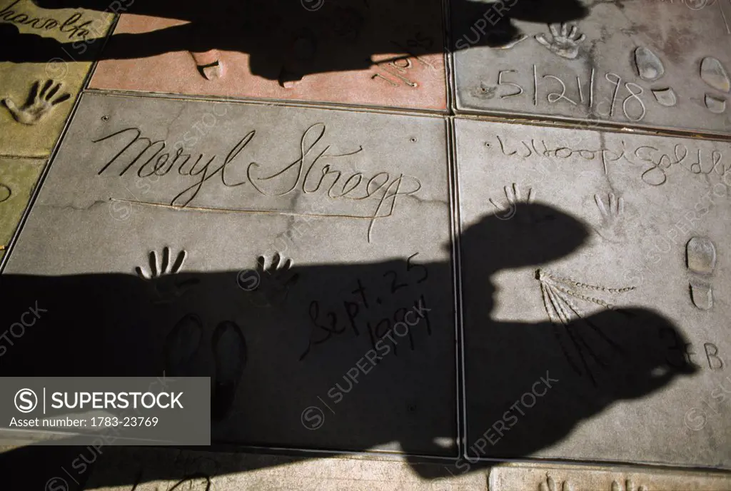 Shadows on handprints of movie stars outside Mann's Chinese theatre, Hollywood Boulevard, Los Angeles, California, USA.