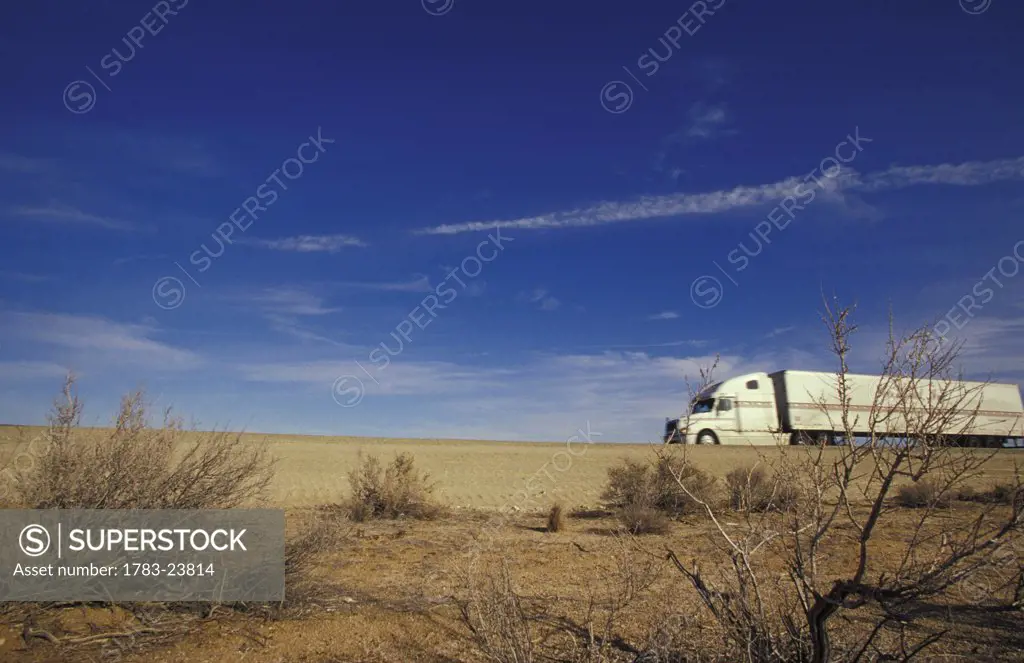 Truck driving through Mojave Desert, California
