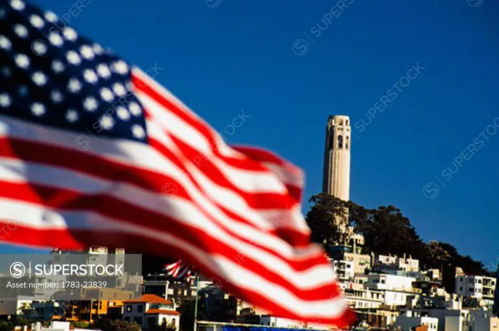 American flag and Colt tower, San Francisco, California, USA.