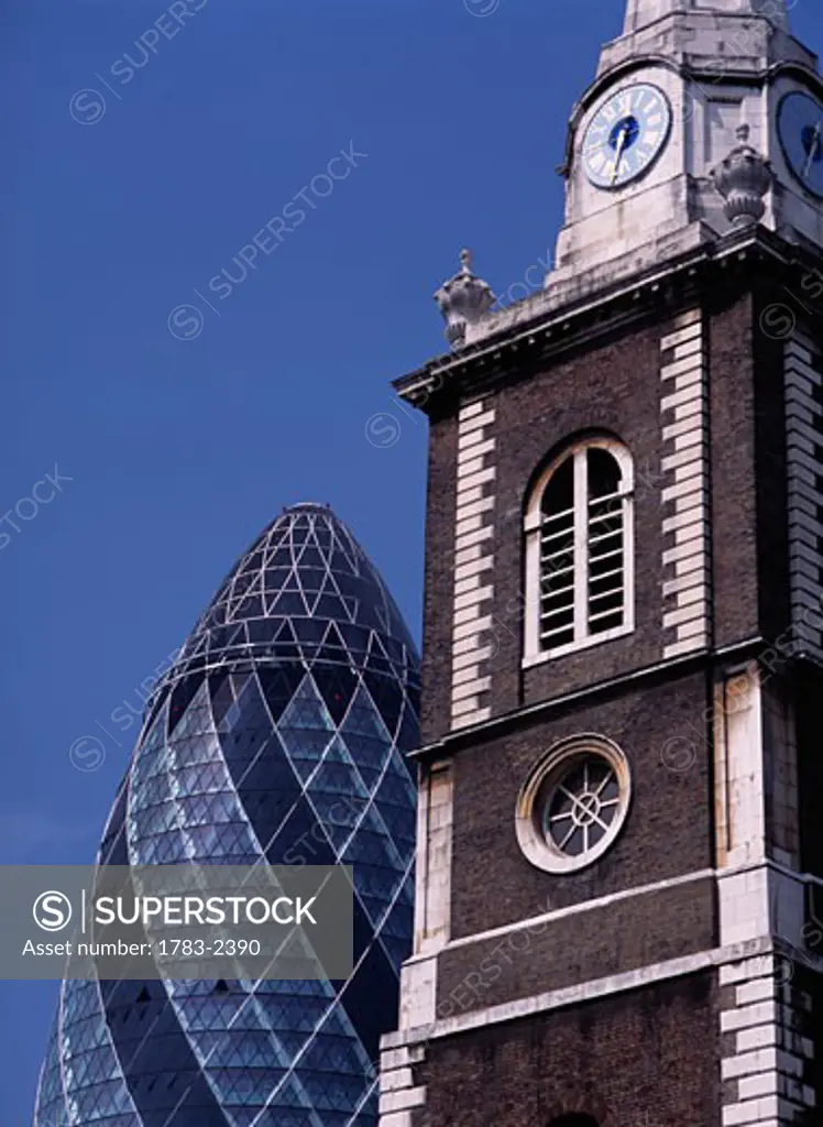 Small church and the Swiss Re Building.  London, UK.