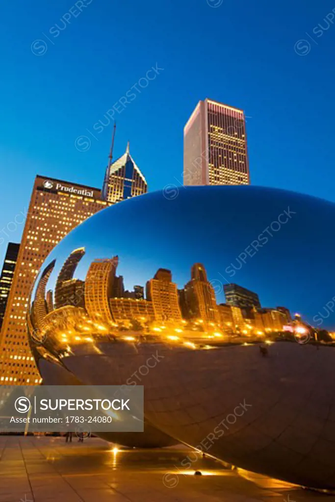 City reflected in Cloud Gate in Millennium Park, dusk, Chicago, Illinois, USA.