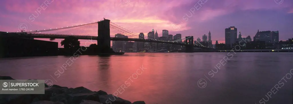 Sunset over Lower Manhattan and Brooklyn Bridge, New York City, New York State, USA.