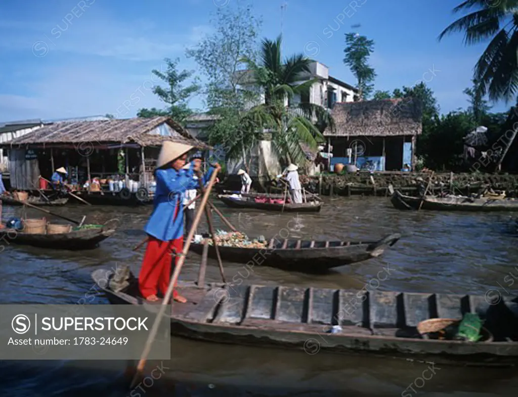Women rowing, Mekong Delta, Vietnam .