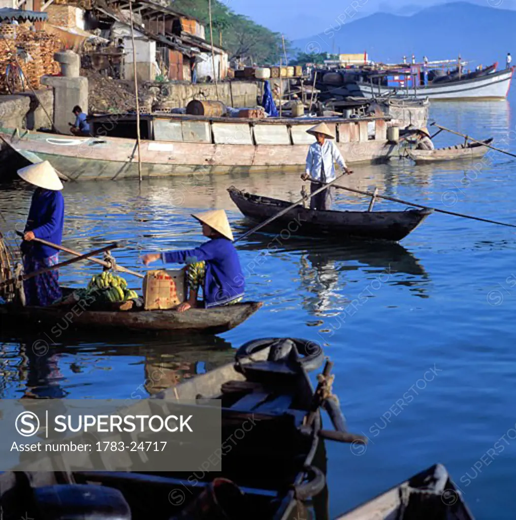 People on boats at riverfront market, Danang, Vietnam.