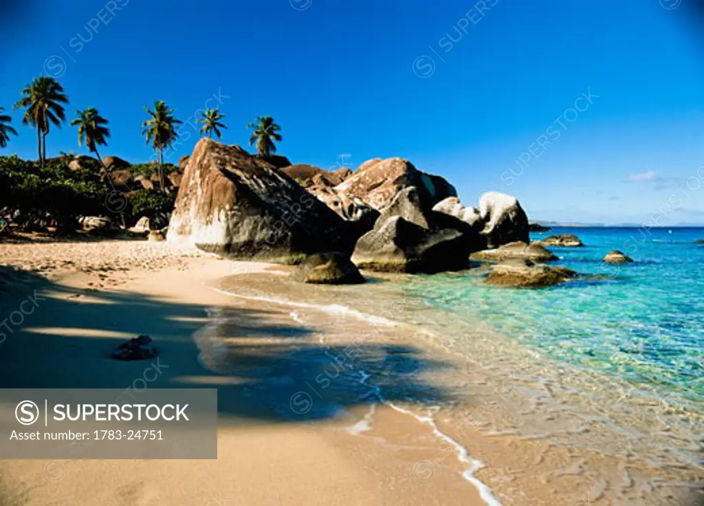 Boulders and palm trees on tropical beach, Baths, Virgin Gorda, British Virgin Island.