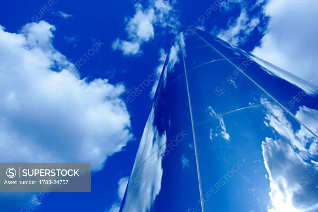 Glass obelisk with blue sky and cloud reflections, Millennium Centre, Cardiff , Wales 