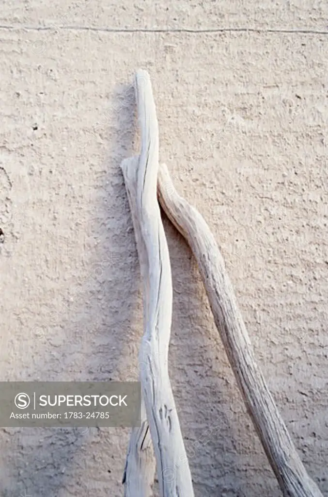 White sticks leaning against white wall, Tarim, The Yemen ® Luke White / Axiom