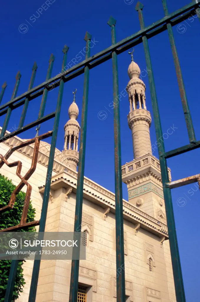 Low angle view through a gate of two minarets on the Badr Mosque, Port Tewfik, Suez Canal, Egypt