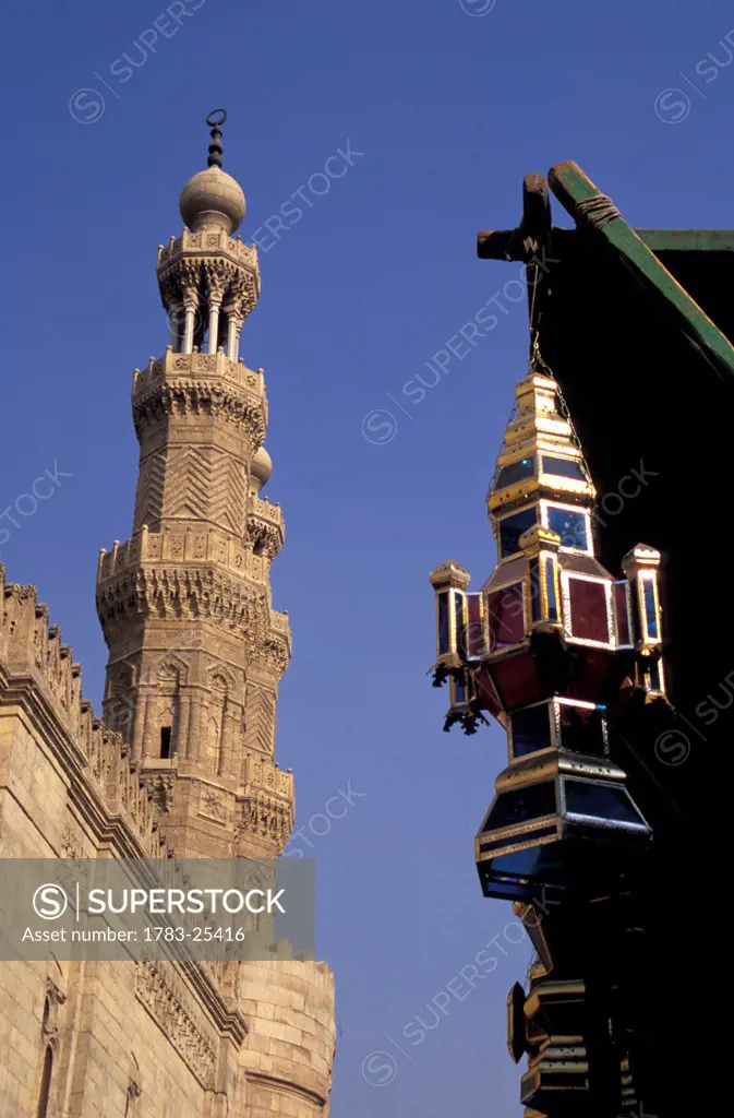 Low angle view of Ramadan lamp and Minarets above Bab Zuwayla, Cairo, Egypt