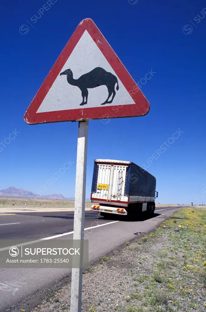 Camel roadsign and truck, near Isfahan, Iran