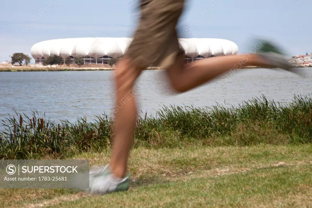 Man running in front of 2010 Stadium