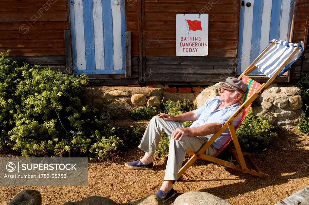 Man sitting in a deckchair in Steephill Cove, Ventnor, Isle of Wight