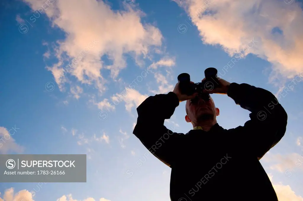 Man using binoculars, Pelotas stream, Pelotas, Rio Grande Do Sul, Brazil