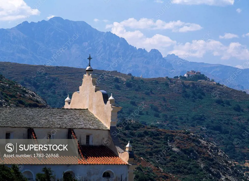 Church and mountains, Haute_Balagne view towards Pigna Porto, Corsica