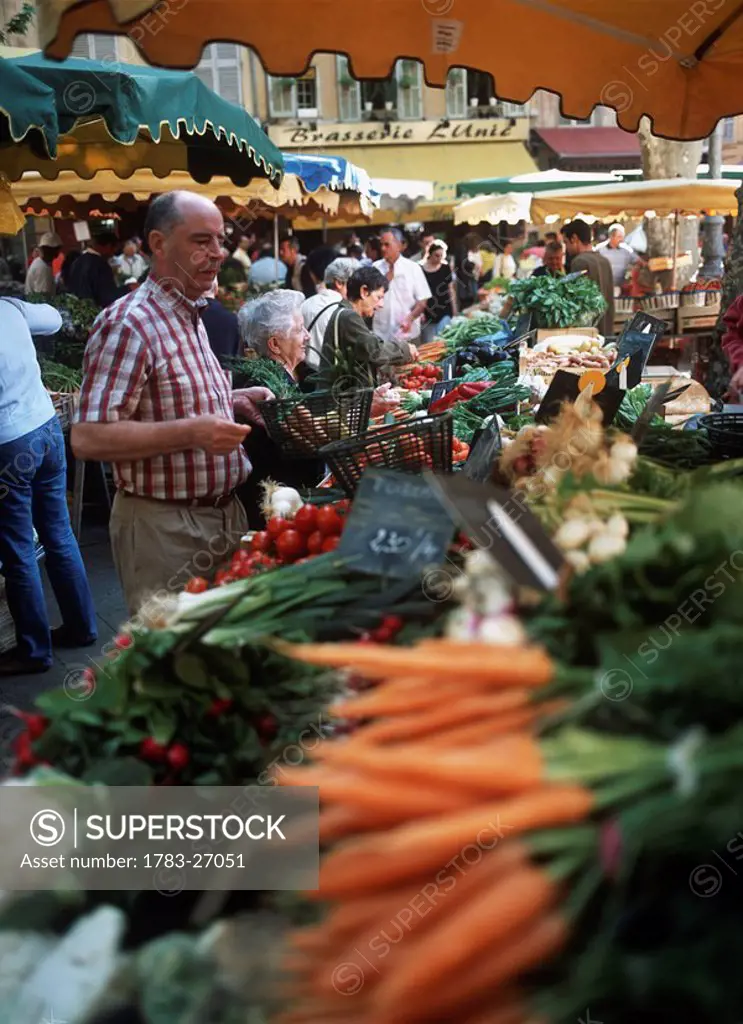 People buying produce in market, Aix_en_Provence, France. 