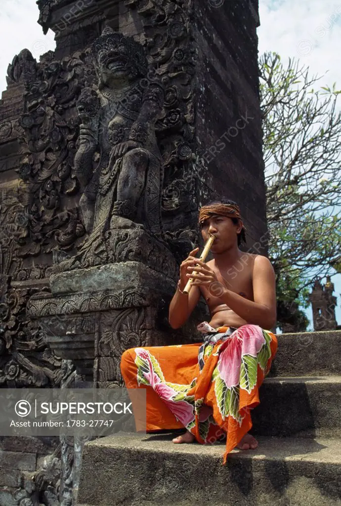 Flute player at Temple, Bali, Indonesia.