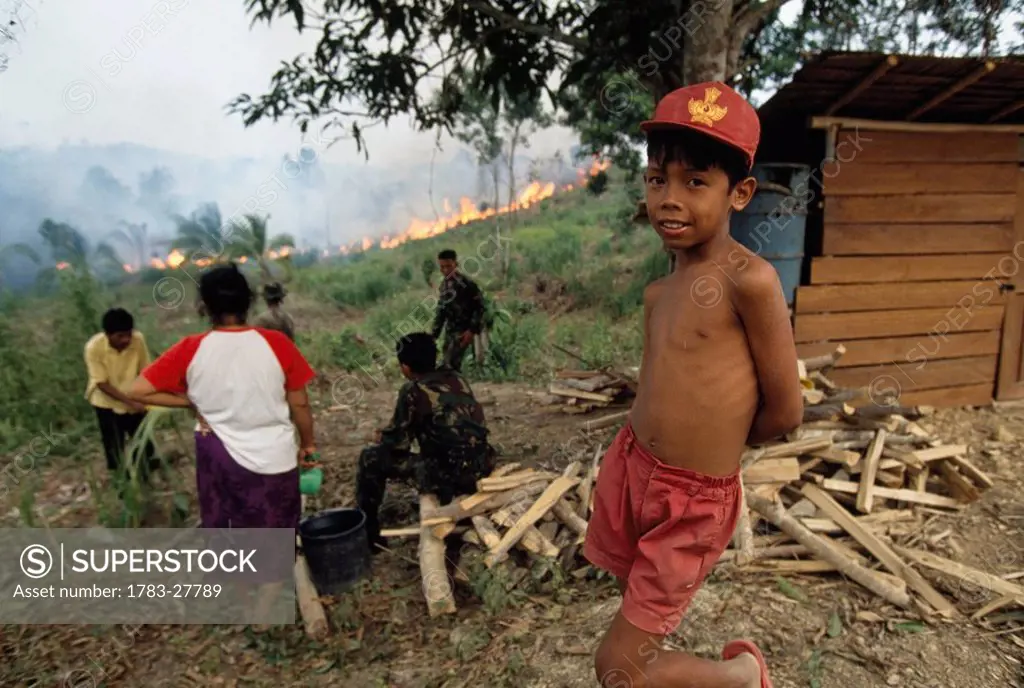 Villagers look on as fire approaches, Kalimantan, Indonesia