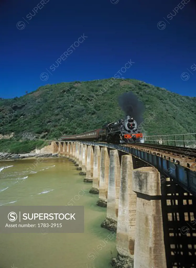 The Outeniqua Choo-Tjoe steam train crossing bridge at the mouth of Kaaimans River, near the town of Wilderness on the Garden Route, South Africa. 