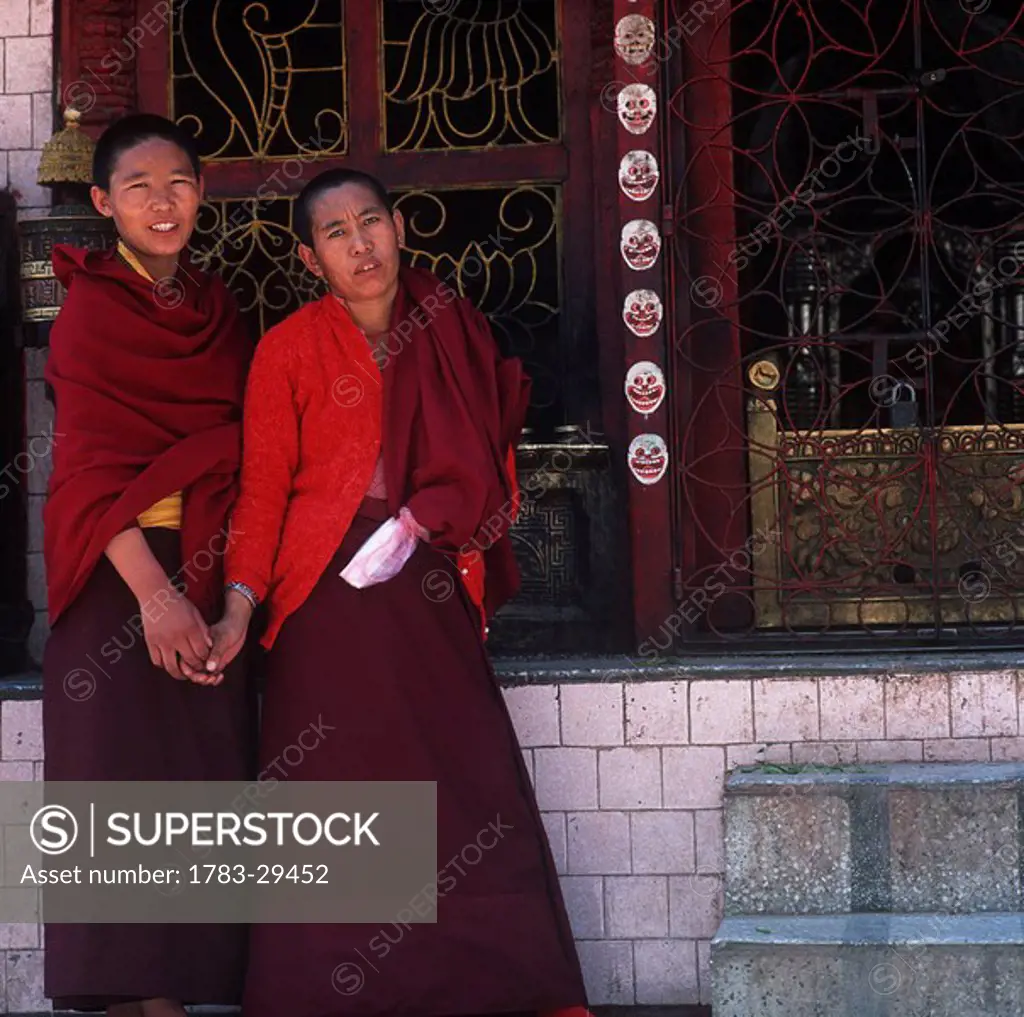 Two Buddhist monks at shrine, Katmandu, Nepal