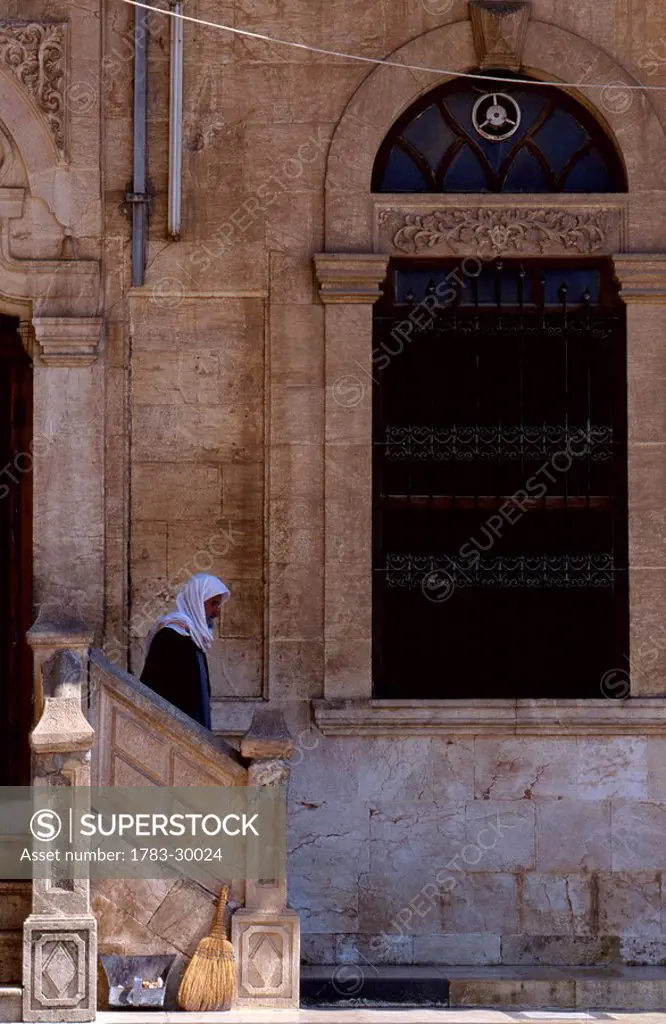Man walking out of building, Syria