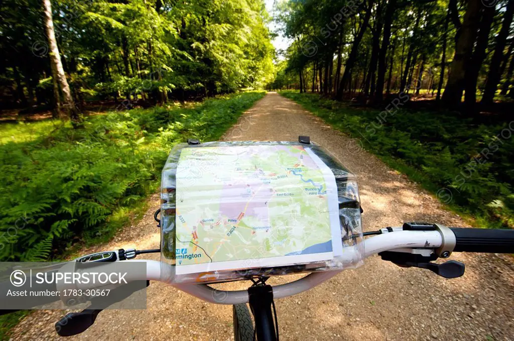 Cyclist with map following a cycle route around Brockenhurst, New Forest National Park