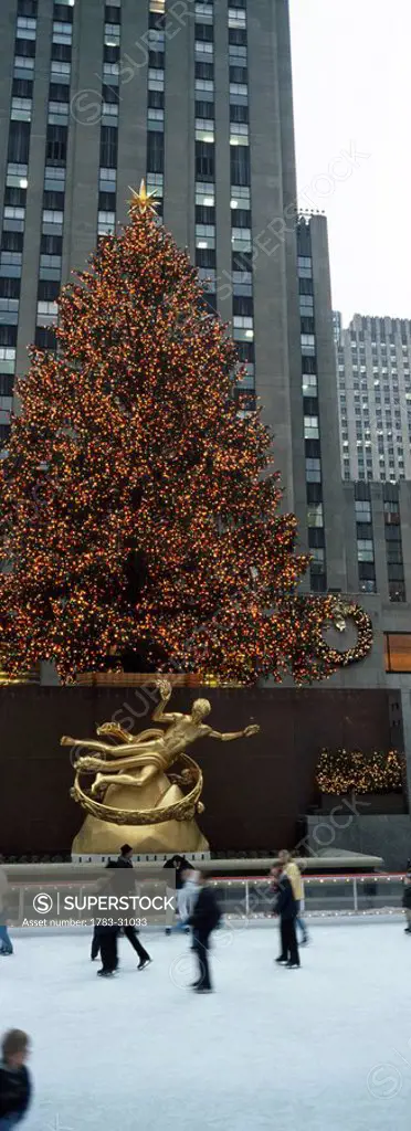 Christmas Tree, Skaters on ice rink, Rockerfella Plaza. New York City, USA