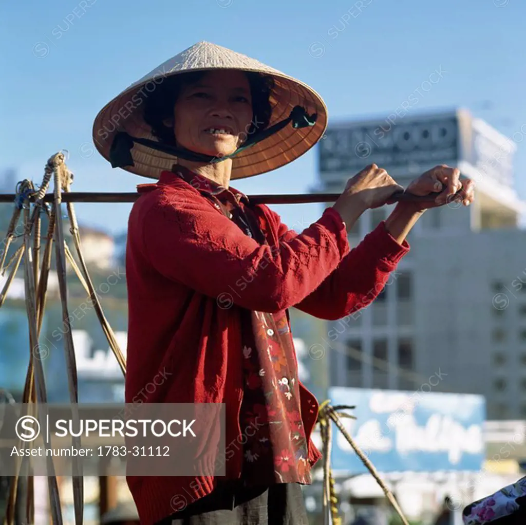 Woman carrying shoulder baskets, Dalat, Vietnam