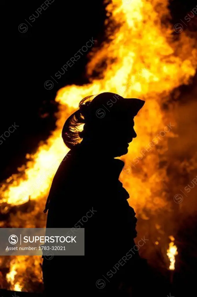 Silhouette of man dressed as pirate in front of bonfireLewes, East Sussex. Silhouette of man dressed as pirate in front of bonfire