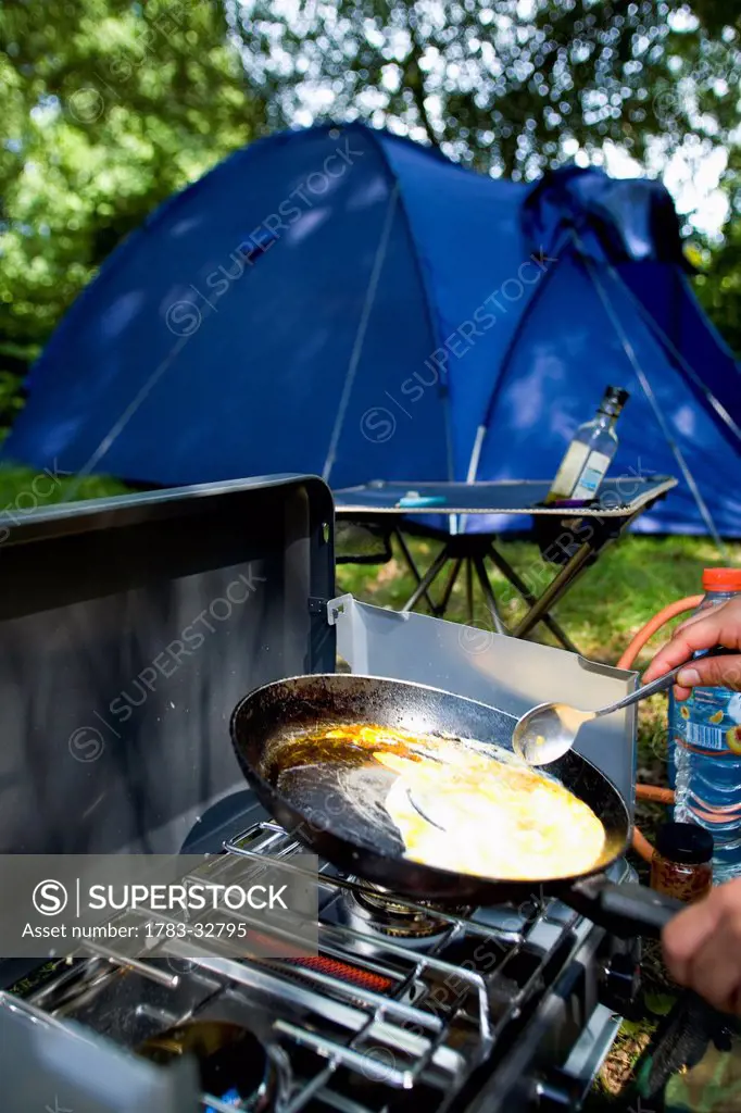 New Forest, Hampshire, Uk. Cooking On Gas Stove, Camping And Tent