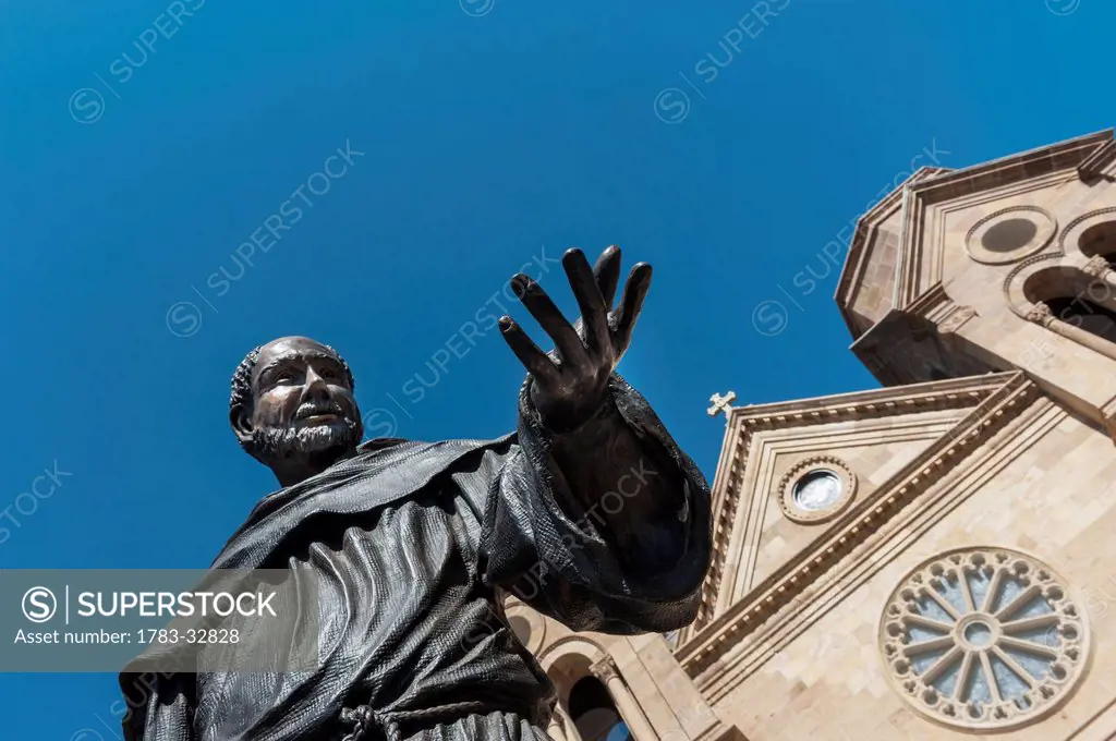 A Statue Of St. Francis Of Assisi Prominently Adorns The Front Entrance Of The St. Francis Cathedral In Santa Fe, New Mexico, Usa