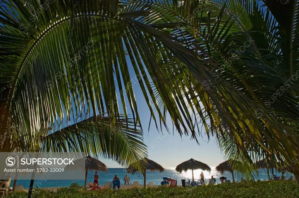 Tourists Relaxing At Ancon Beach (Playa Ancon) At Sunset, Trinidad,Cuba