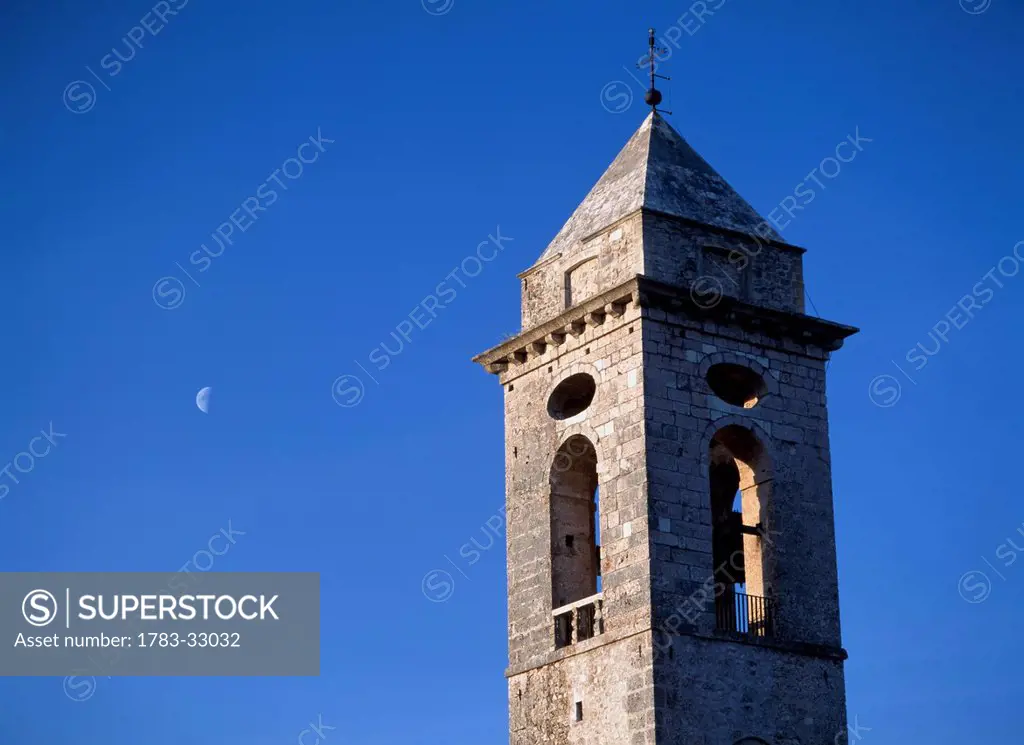 The Belltower Of The Church Of Santo Stefano Di Sessanio With The Moon Behind At Dusk,Abruzzo,Italy.
