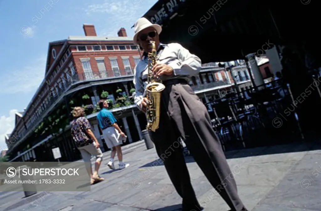Jazz saxophonist Dr. Saxtum in front of Cafe du Monde, New Orleans, Louisiana.  