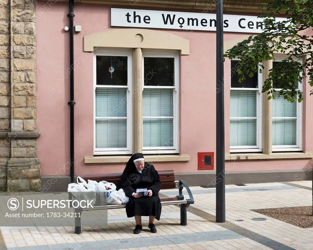 United Kingdom, Northern Ireland, County Londonderry, Nun With Her Supermarket Shopping Outside Womans Centre; Derry