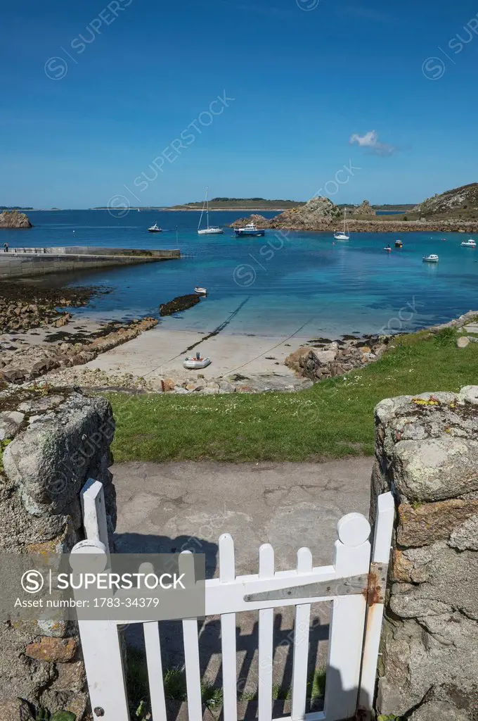 White Gate Leading Out To The Beach And Quayside At St Agnes, Isles Of Scilly, Cornwall, Uk, Europe